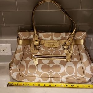 - Tan and white coach purse.